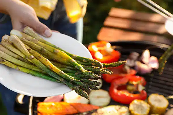 2023 Food and Beverage Trends Report A plate of asperagus and vegetables on a barbecue