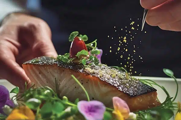 Food scientist seasoning fish